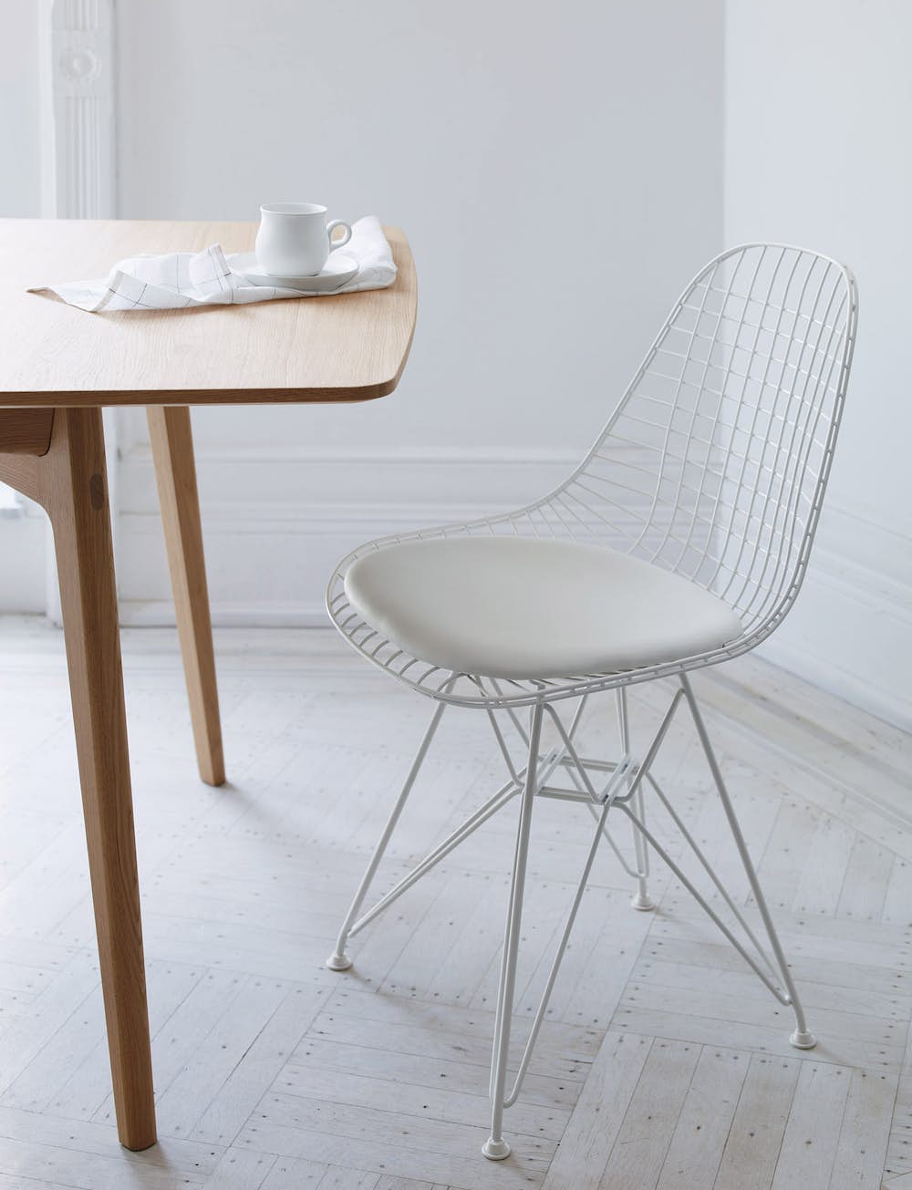 Eames Wire Side Chair with Seat Pad at a dining table
